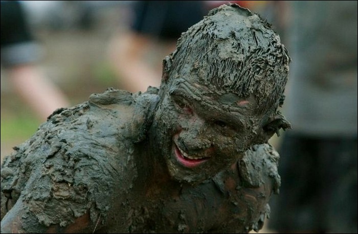 Funny people at mud festival and in mud therapy