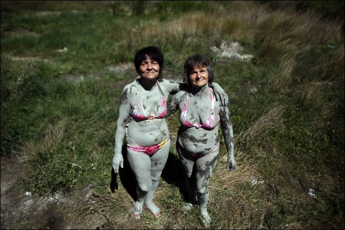 Funny people at mud festival and in mud therapy